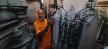 AYODHYA, INDIA - AUGUST 4: A sadhu in reverence next to stone pillars prepared for the Ram Janmabhoomi temple at the Ram Janm Bhoomi Nyas Karsevak Puram on August 4, 2020 in Ayodhya, India. Prime Minister Narendra Modi will on Wednesday attend a public function on laying of the foundation stone of 'Shree Ram Janmabhoomi Mandir' at Ayodhya. Ram Janmabhoomi Teerth Kshetra, the trust set up for the construction and management of Ram temple, has invited 175 eminent guests for the foundation stone-laying ceremony after personally discussing with BJP veterans L K Advani and Murli Manohar Joshi, lawyer K Parasaran and other dignitaries. (Photo by Deepak Gupta/Hindustan Times via Getty Images)