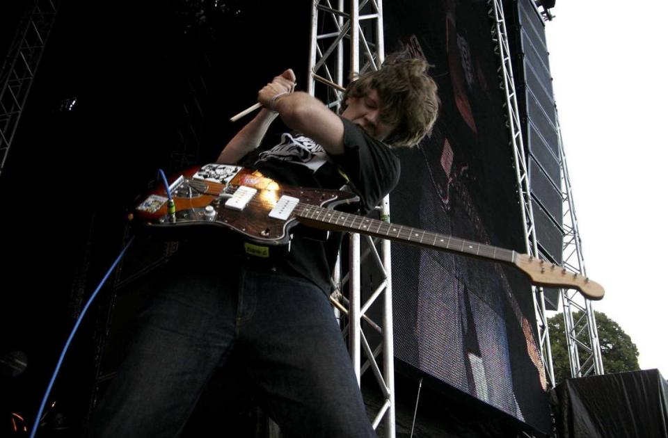 Thurston Moore plays his guitar with the aid of a drumstick during a Sonic Youth performance at a music festival in Sweden in 2008.