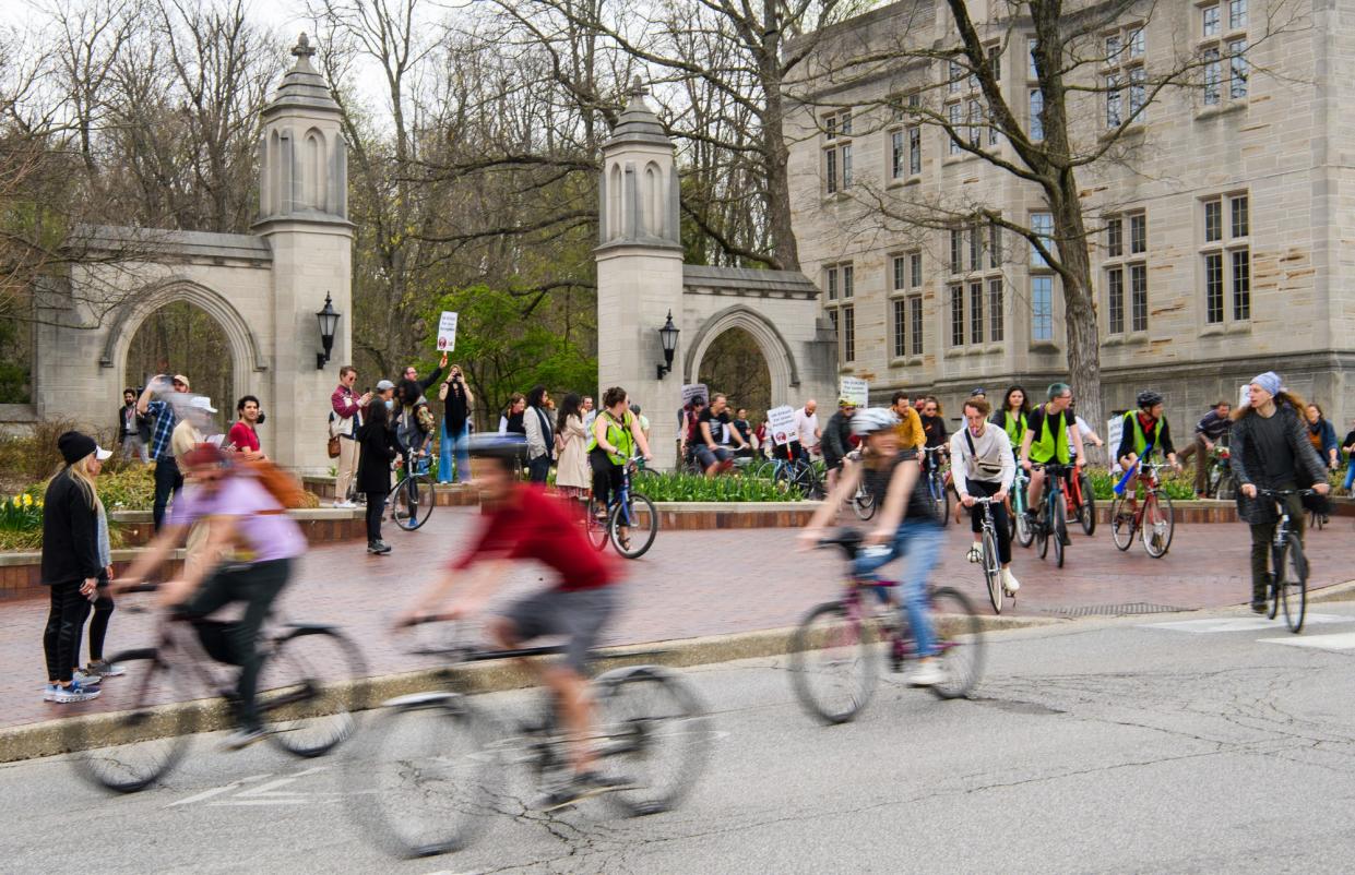 Bicycle riders take off from the Sample Gates last April. Numerous bike thefts have been reported around town and on campus.