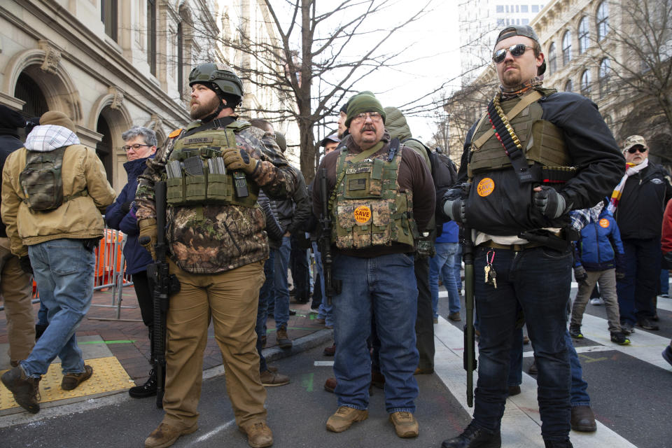 Gun-rights advocates, from Ohio, stand in downtown Richmond, Va., during a gun-rights rally at the Virginia State Capitol, Monday, Jan. 20, 2020. The rally was hosted by the Virginia Citizens Defense League but drew interest from groups across the country. (Mike Morones/The Free Lance-Star via AP)