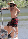 <p>Jason Momoa wears a wide-brimmed hat as he heads out on a boat with friends in Hawaii on Dec. 9. </p>