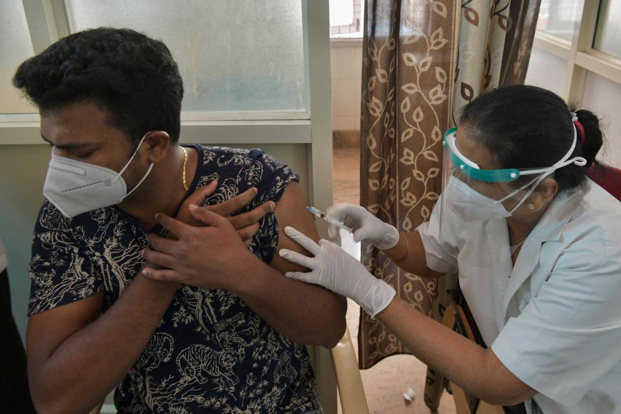 <p>A medical worker inoculates a man with a dose of Covid-19 vaccine at a vaccination centre in Bangalore on 7 May, 2021.</p> (AFP via Getty Images)