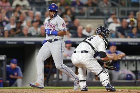 Jul 20, 2018; Bronx, NY, USA; New York Mets designated hitter Yoenis Cespedes (52) scores a run ahead of a tag by New York Yankees catcher Gary Sanchez (24) on a single by left fielder Michael Conforto (not pictured) during the fifth inning at Yankee Stadium. Mandatory Credit: Brad Penner-USA TODAY Sports