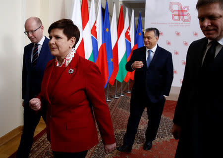 Visegrad Group (V4) member nations' Prime Ministers, Bohuslav Sobotka of the Czech Republic, Poland's Beata Szydlo, Hungary's Viktor Orban and Slovakia's Robert Fico walk after posing for a family photo during a summit in Warsaw, Poland March 2, 2017. REUTERS/Kacper Pempel