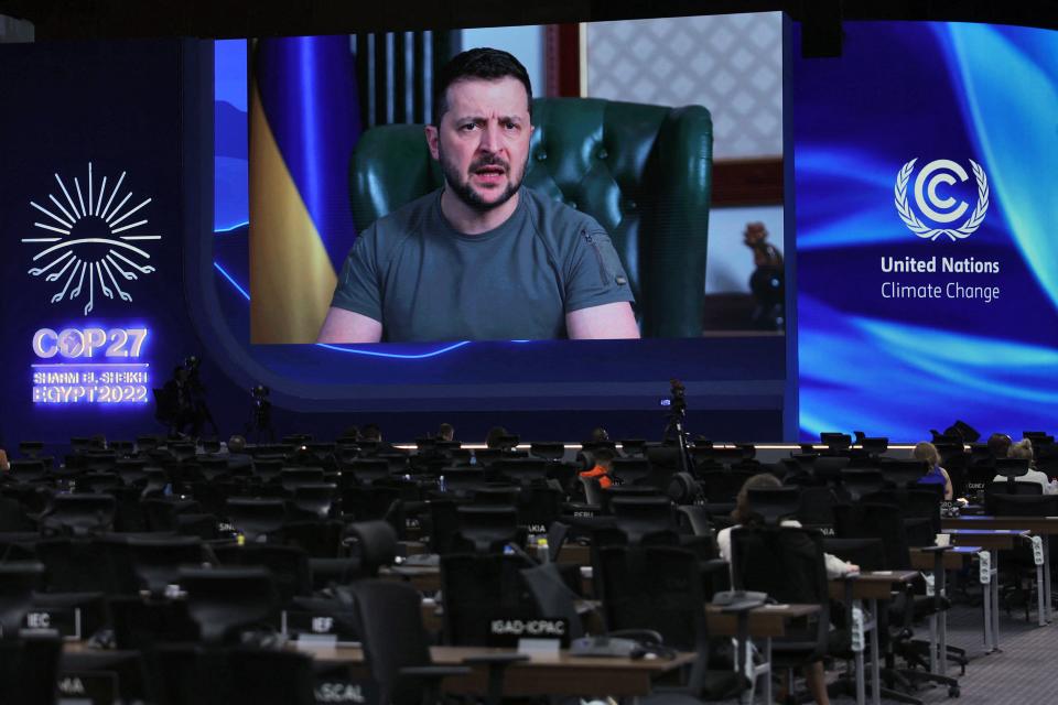 Ukrainian president Volodymyr Zelensky appears on a screen as he delivers a speech at the Cop27 climate conference at the Sharm el-Sheikh International Convention Centre, in Egypt’s Red Sea resort city of the same name, on 8 November 2022 (AFP via Getty Images)