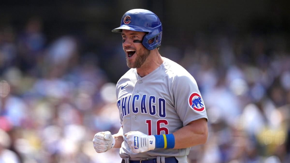 Los Angeles Dodgers shortstop Mookie Betts, top, throws out Chicago Cubs'  Patrick Wisdom at first after forcing out Cody Bellinger at second during  the eighth inning of a baseball game in Chicago