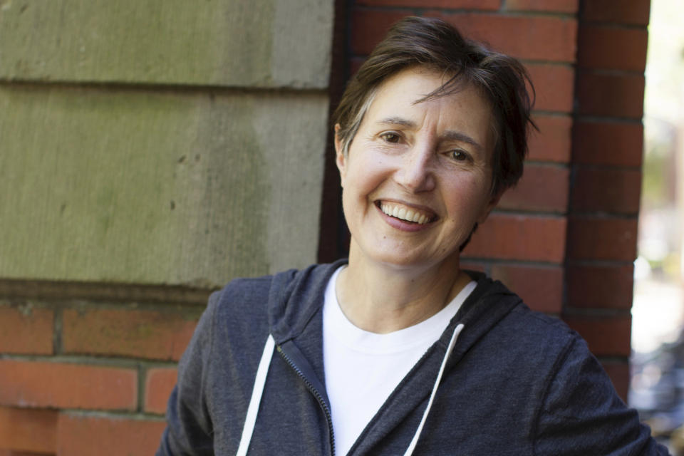 In this image provided by Harvard University photo, Associated Press staff photographer Elise Amendola poses in Harvard Yard on May 2015, in Cambridge, Mass. Amendola, who recently retired from the AP, died Thursday, May 11, 2023, at her home in North Andover, Mass., after a 13-year battle with ovarian cancer. She was 70. (Stephanie Mitchell/Harvard University photo via AP)