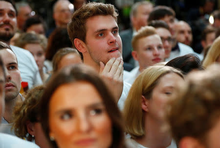 People at the Christian Democratic Union (CDU) headquarters react on first exit polls in the German general election (Bundestagswahl) in Berlin, Germany, September 24, 2017. REUTERS/Fabrizio Bensch