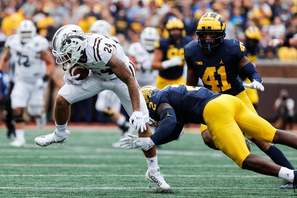 Western Michigan wide receiver Skyy Moore is tackled by Michigan defensive back Brad Hawkins during the first half in Ann Arbor on Saturday, Sept. 4, 2021.