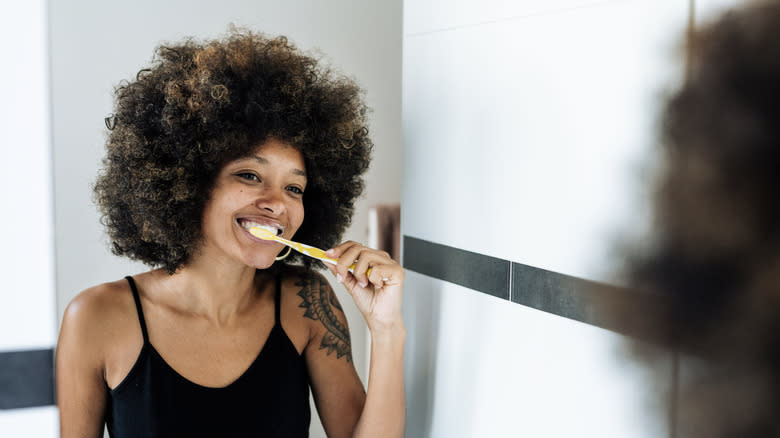 Woman brushing teeth