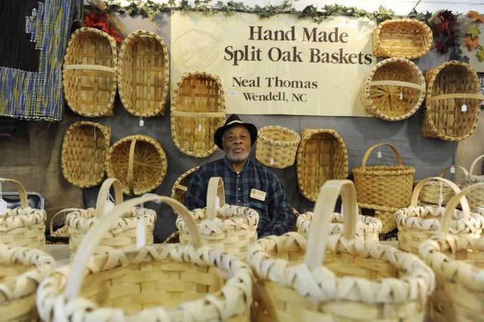 Neal Thomas mans his booth filled of handmade, split-oak baskets in the Village of Yesteryear at the N.C. State Fair in Raleigh. Thomas has been weaving baskets for 50 years.