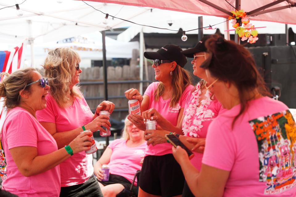 Members of I Only Smoke When I Drink, an "all-girl" team, crack open some drinks on May 18, 2023, during the Memphis in May World Championship Barbecue 
 Cooking Contest at Tom Lee Park in Downtown Memphis.