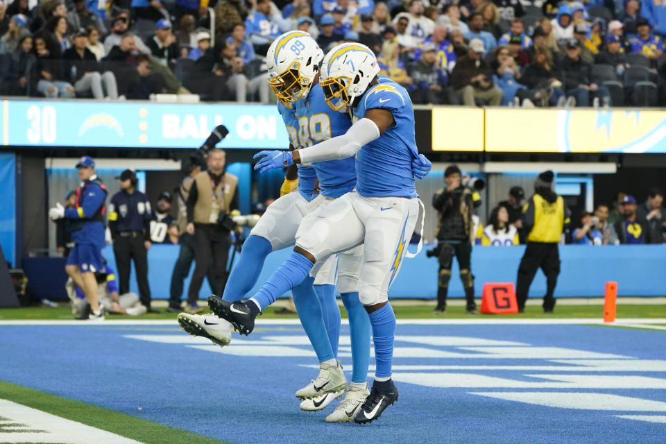 Los Angeles Chargers tight end Donald Parham Jr. (89) and tight end Gerald Everett (7) celebrate a touchdown by =Donald Parham Jr. during the second half of an NFL football game against the Los Angeles Rams Sunday, Jan. 1, 2023, in Inglewood, Calif. (AP Photo/Marcio Jose Sanchez)