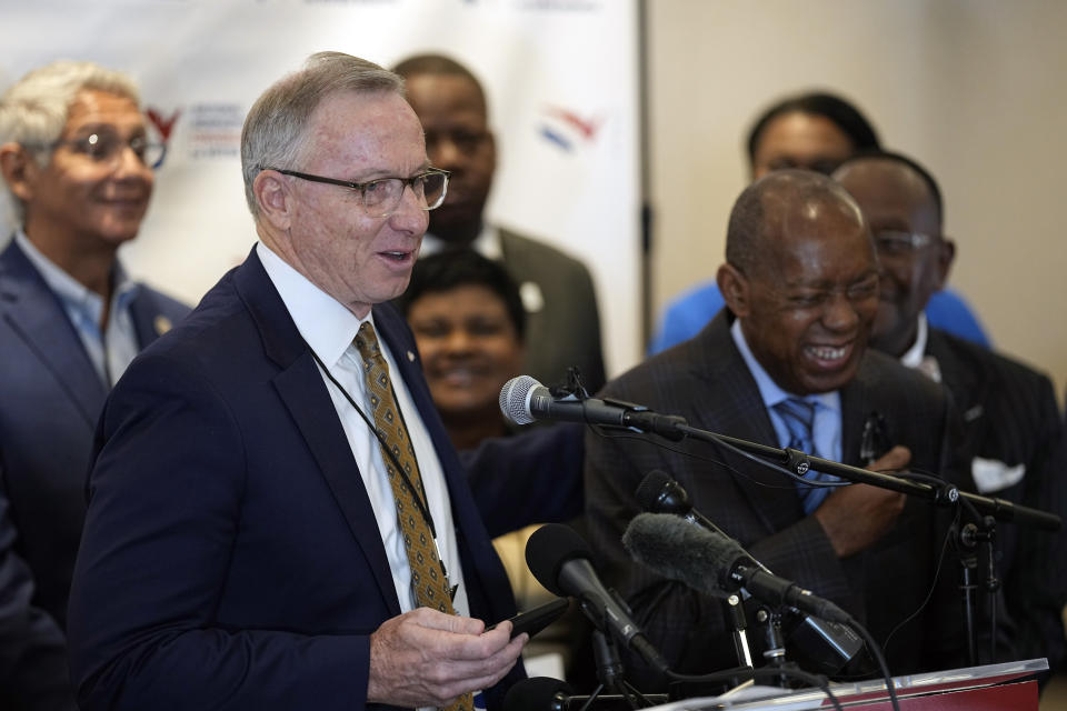 Mayor John Giles, left, of Mesa, Ariz., makes Houston Mayor Sylvester Turner laugh during his opening remarks at a voting rights news conference Tuesday, Sept. 20, 2022, in Houston. The National Nonpartisan Conversation on Voting Rights is holding meetings and seminars in Houston Tuesday and Wednesday. (AP Photo/David J. Phillip)