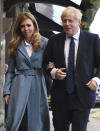 Britain's Prime Minister Boris Johnson arrives, accompanied by partner Carrie Symonds, ahead of the annual scheduled Conservative Party Conference in Manchester, England, Saturday Sept. 28, 2019. The ruling Conservative Party are continuing with their party conference, despite government lawmakers voting against the party request for a three-day recess to allow extra time for the event. (Stefan Rousseau/PA via AP)
