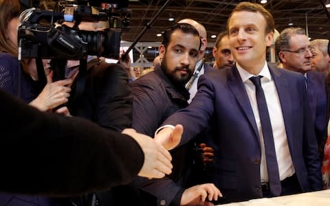 Emmanuel Macron and Alexexandre Benalla (L), then his presidential campaign security chief, at the Paris agricultural fair in March 2017 - Credit: Christophe Ena/AP