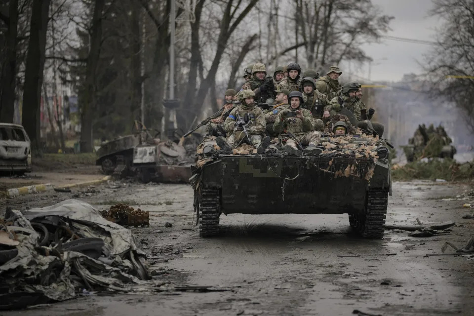 FILE - Ukrainian servicemen ride on a fighting vehicle outside Kyiv, Ukraine, April 2, 2022. Kyiv was a Russian defeat for the ages. It started poorly for the invaders and went downhill from there. (AP Photo/Vadim Ghirda, File)