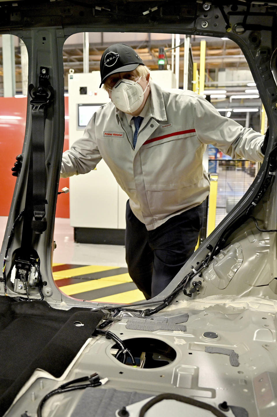 British Prime Minister Boris Johnson visits the Nissan Motor Co. plant, in Sunderland, England, Thursday, July 1, 2021. Japanese carmaker Nissan and two partners announced plans to invest 1 billion ($1.4 billion) pounds to produce a new model of an all-electric vehicle and batteries in northeast England, a major victory for the U.K. government’s efforts to attract jobs and investment following the country’s departure from the European Union. ( Jeff J Mitchell/Pool Photo via AP)