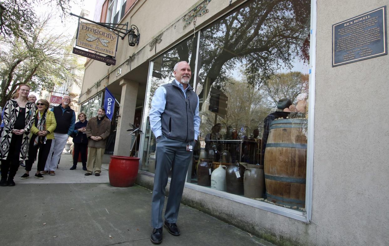 City Manager Rick Howell smiles as he checks out his plaque during a surprise celebration for him held Thursday afternoon, March 16, 2023, outside the Dragonfly Wine Market in Shelby.