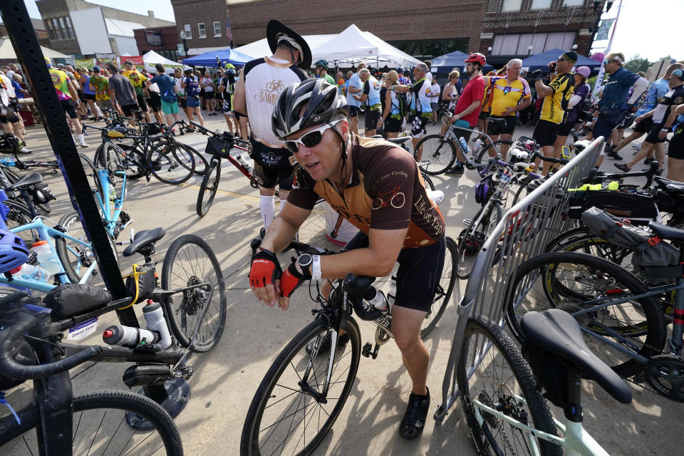 Associated Press reporter Dave Skretta sits on his bike while taking a break from riding in The Des Moines Register's annual bike ride across Iowa, also known as RAGBRAI, Tuesday, July 25, 2023, in Jefferson, Iowa. (AP Photo/Charlie Neibergall)