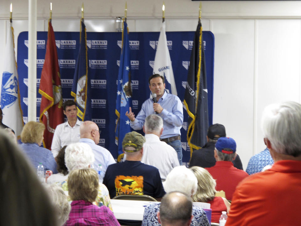 Former Attorney General and Nevada Senate Republican candidate Adam Laxalt, who served as a judge advocate general in the Navy in Iraq, gives a campaign speech at the VFW in Reno, Nev., on Sept. 1, 2022, in his bid to unseat Democratic Sen. Catherine Cortez Masto, as retired Army Capt. Sam Brown, left, listens. Brown, who was nearly killed in an explosion in combat in Afghanistan, lost to Laxalt in a sometimes heated GOP Senate primary but has since rallied around his campaign. (AP Photo/Scott Sonner)