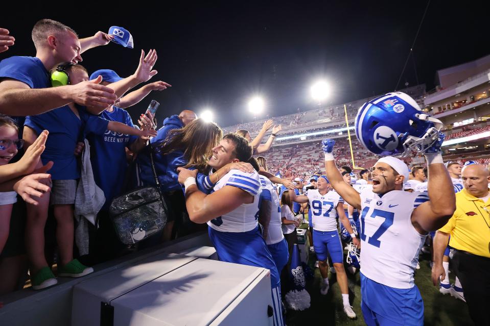 Brigham Young Cougars tight end Isaac Rex (83) and long snapper Dalton Riggs (47) celebrate the win over the Arkansas Razorbacks at Razorback Stadium in Fayetteville on Saturday, Sept. 16, 2023. BYU won 38-31. | Jeffrey D. Allred, Deseret News