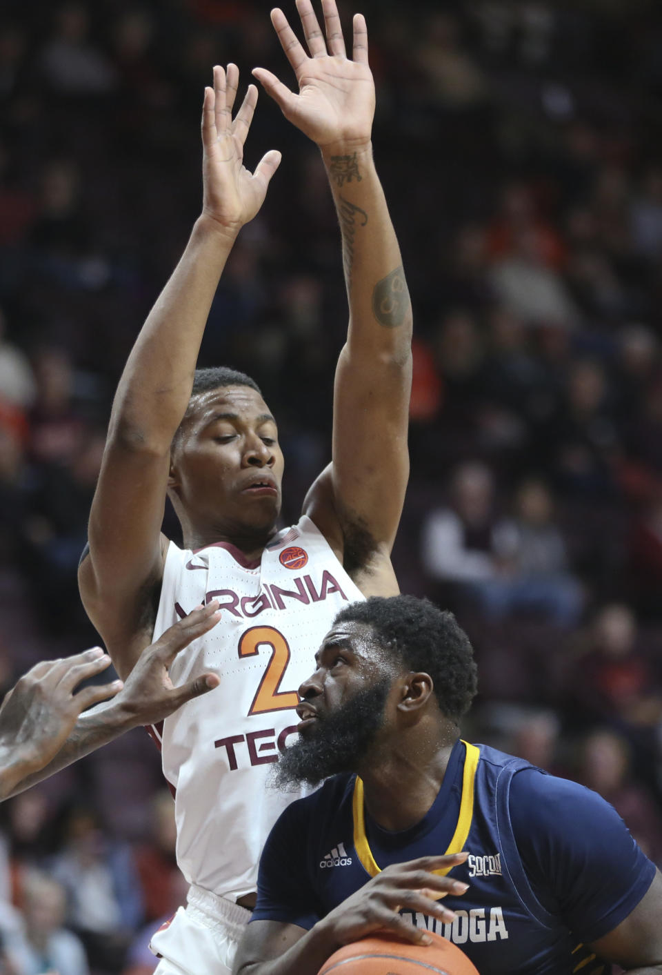Chattanooga's David Jean-Baptiste, foreground, looks to shoot while guarded by Virginia Tech's Landers Nolley II (2) in the first half of an NCAA college basketball game, Wednesday, Dec. 11, 2019, in Blacksburg, Va. (Matt Gentry/The Roanoke Times via AP)