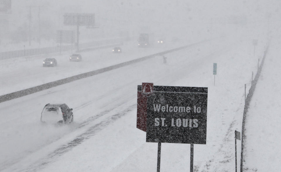Few cars drive on Interstate 44 in Fenton, Mo., Sunday, Jan. 5, 2014. Snow-covered roads and high winds were creating dangerous driving conditions from Missouri to Delaware on Sunday ahead of a "polar vortex" that'll bring below-zero temperatures not seen in years to much of the nation in the coming days, likely setting records. (AP Photo/St. Louis Post-Dispatch, J.B. Forbes)