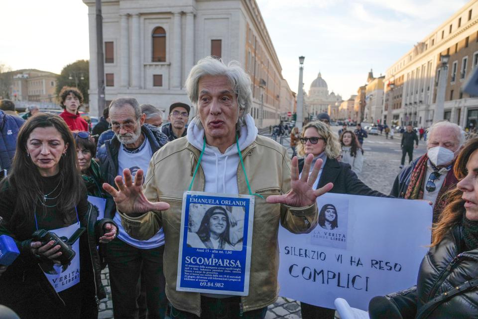 Pietro Orlandi wears a placard with a picture of his sister Emanuela during a sit-in near Saint Peter's Basilica, in Rome, Saturday, Jan. 14, 2023. The Vatican marked the 40th anniversary of the disappearance of the teenage daughter of a Vatican employee by confirming the existence of new leads “worthy of further investigation” in hopes of finally getting to the bottom of one of the Holy See’s enduring mysteries. (AP Photo/Gregorio Borgia, File)