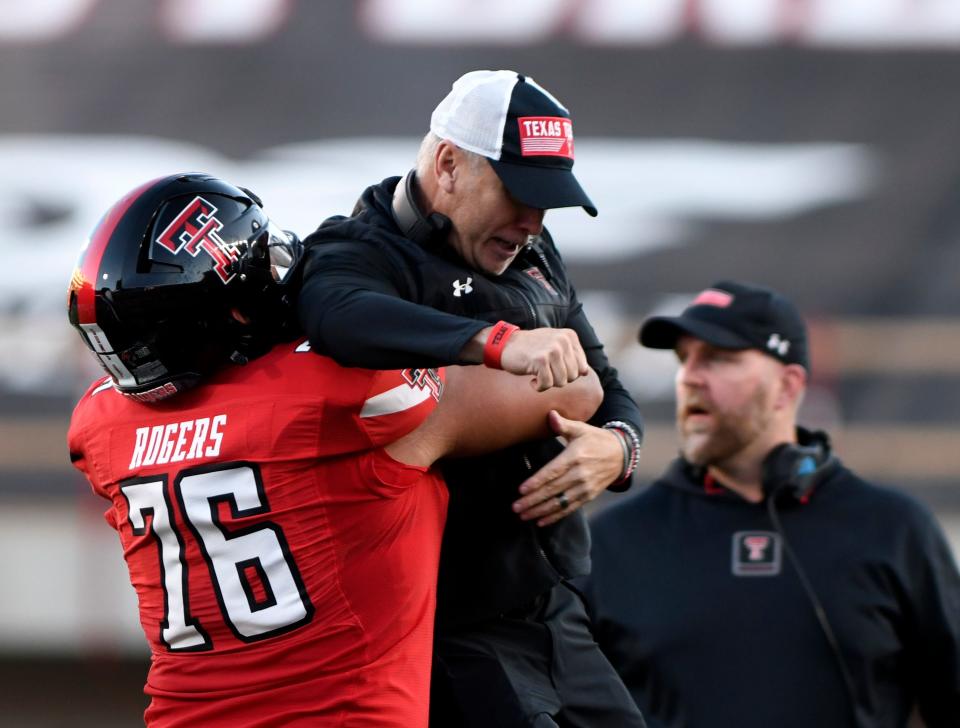 Texas Tech offensive tackle Caleb Rogers (76) lifts Tech coach Joey McGuire in celebration during the Red Raiders' 35-28 victory Nov. 2 against TCU. The Red Raiders will end the season facing California on Dec. 16 at the Independence Bowl in Shreveport, Louisiana.