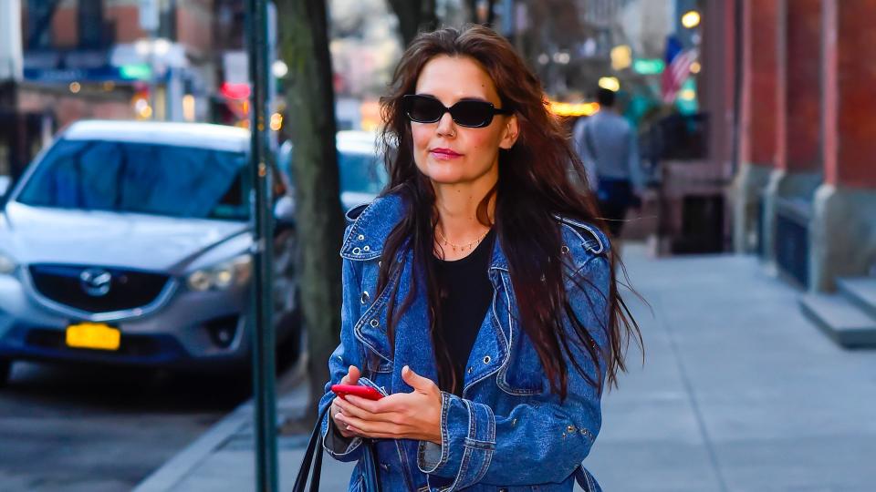 Katie Holmes is seen walking on March 25, 2024 in New York City wearing a denim trench coat