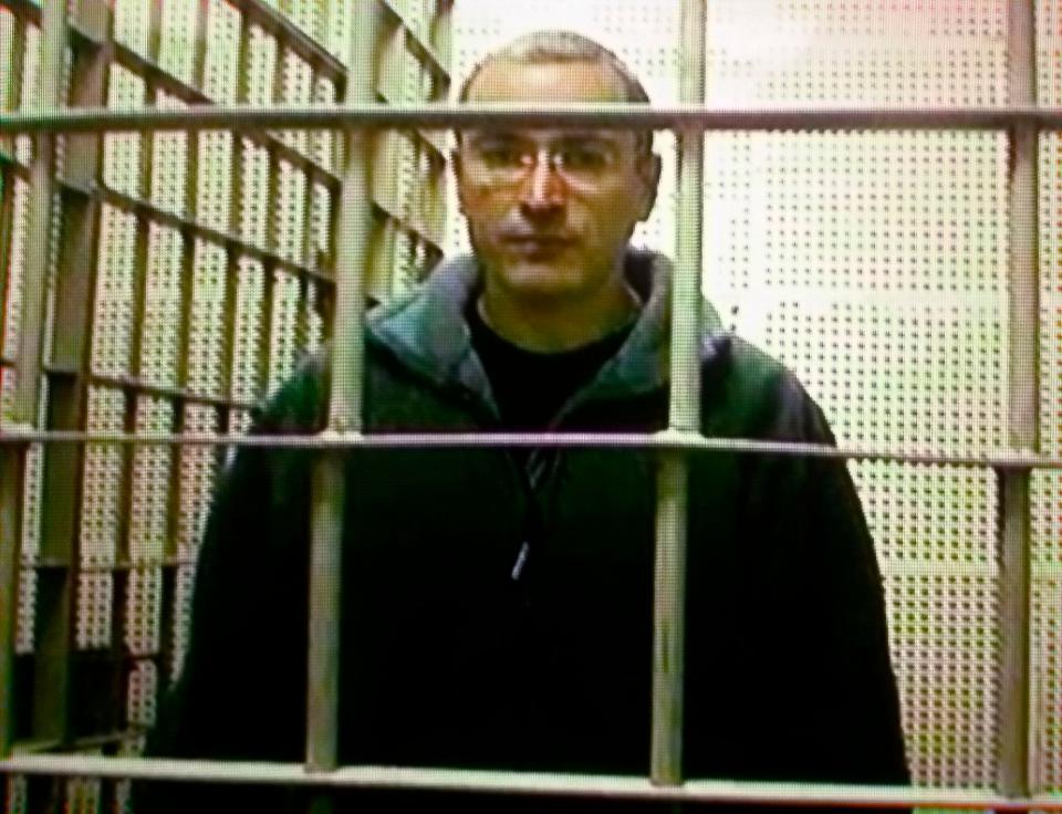 Mikhail Khodorkovsky faced trial from the inside of a cage. He would be convicted and sentenced to nine years in a prison camp.