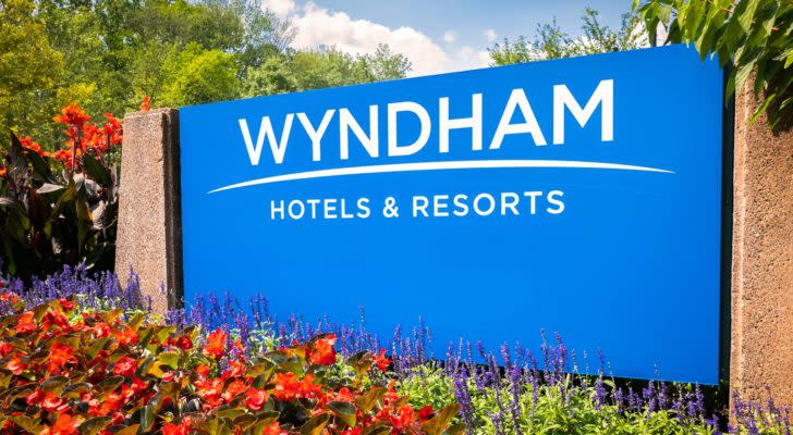 A sign for Wyndham Hotels & Resorts (WH) in bright blue.