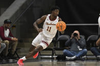 Charleston guard Kobe Rodgers (11) handles the ball during the first half of an NCAA college basketball game in the championship of the Coastal Athletic Association conference tournament, Tuesday, March 12, 2024, in Washington. (AP Photo/Terrance Williams)