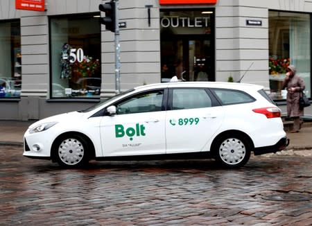 FILE PHOTO: A Bolt (formerly known as Taxify) sign is seen on the taxi car in Riga