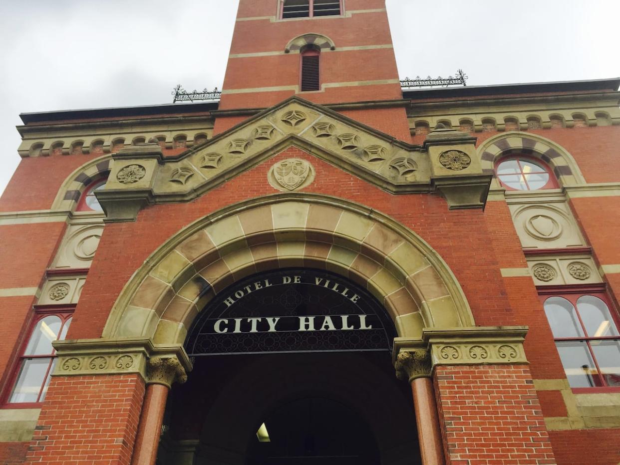 Residents watching the council meeting at Fredericton city hall cheered when the townhouse proposal failed to get enough votes. (Daniel McHardie/CBC - image credit)