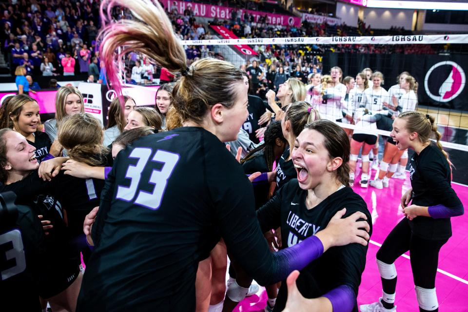 Iowa City Liberty's Cassidy Hartman (33) and Lilah VanScoyoc celebrate their victory after a Class 5A state volleyball semifinal match against Ankeny Centennial