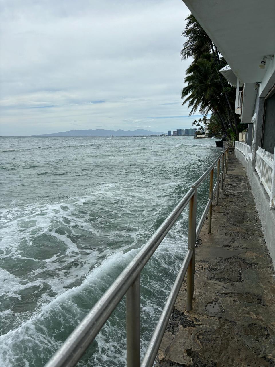 Stronger swells and rising sea levels mean waves crash onto walkways and into seawalls, like at this beach on the eastern end of Waikiki.