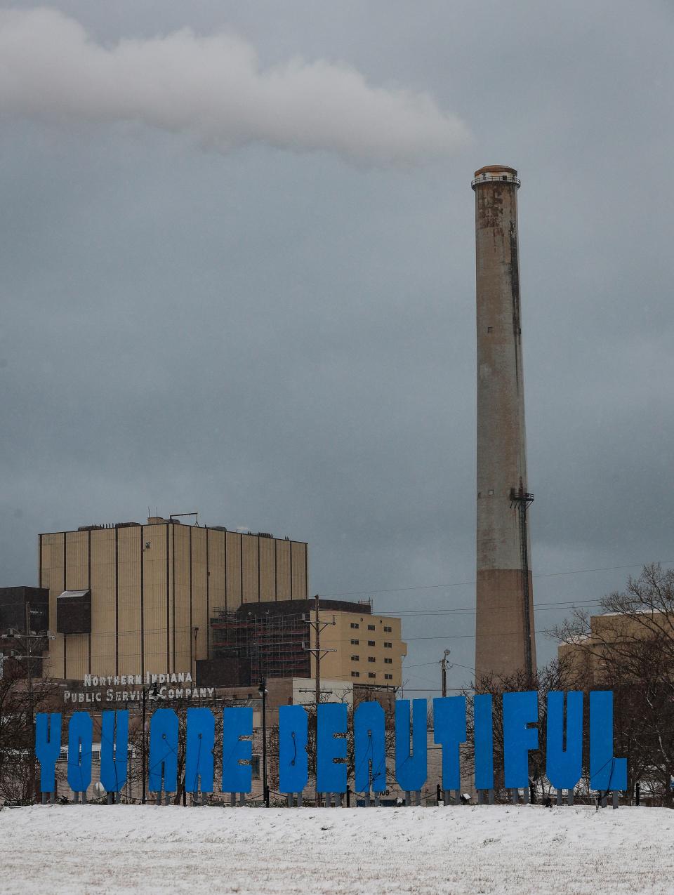 A sign reads "You are beautiful,' in a park next in front of the NIPSCO Michigan City plant on Tuesday, Jan. 27, 2021 in downtown Michigan City, Ind.