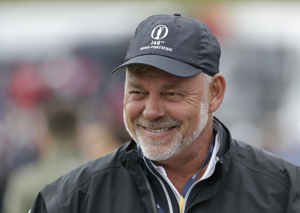 Northern Ireland's Darren Clarke smiles as he speaks to colleagues don the practice range ahead of the start of the British Open golf championships at Royal Portrush in Northern Ireland, Wednesday, July 17, 2019. The British Open starts Thursday. Clarke will hit the first ball at the start of the Open Thursday. (AP Photo/Matt Dunham)