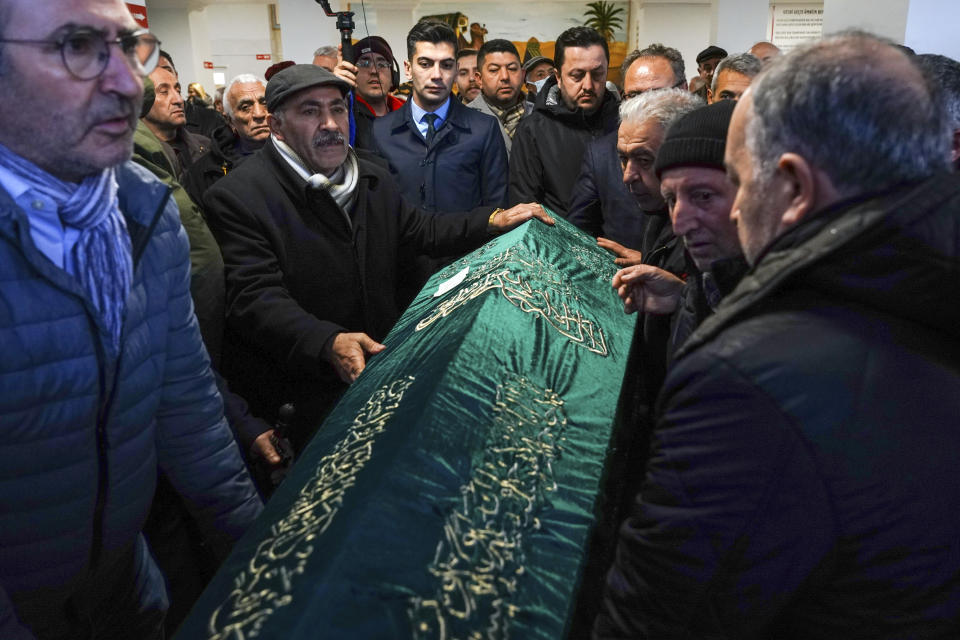 Relatives and friends carry the coffin of Tuncer Cihan, who was killed on an attack to a Catholic church, during his funeral ceremony in Istanbul, Turkey, Monday, Jan. 29, 2024. The Islamic State group has claimed responsibility for an attack on a Roman Catholic church in Istanbul during a Sunday Mass that killed one person. (Sercan Ozkurnazli/Dia Images via AP)