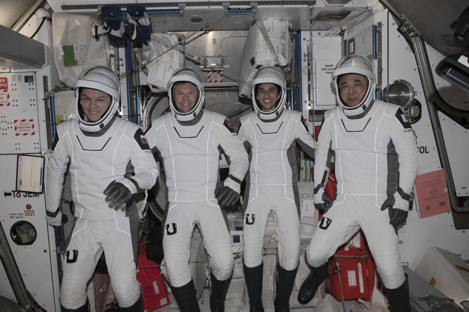 This undated photo provided by NASA shows four Expedition 70 crew mates posing in the pressure suits they will wear when they return to Earth aboard the SpaceX Dragon "Endurance" spacecraft. From left, Roscosmos cosmonaut Konstantin Borisov, ESA (European Space Agency) astronaut Andreas Mohgensen, NASA astronaut Jasmin Moghbeli, and JAXA (Japan Aerospace Exploration Agency) astronaut Satoshi Furukawa. The quartet splashed down off the coast of Florida on Tuesday, March 12, 2024, completing a six-and-a-half-month space research mission. (NASA via AP)