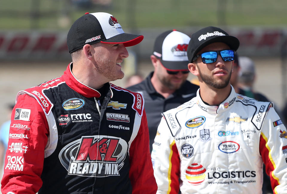 ROSSBURG, OH - JULY 18:  Ty Dillon, driver of the #12 K&L Ready Mix Chevrolet, and Tanner Thorson, driver of the #20 Ohio Logistics Chevrolet, walk to their trucks during qualifying for the NASCAR Camping World Truck Series Eldora Dirt Derby at Eldora Speedway on July 18, 2018 in Rossburg, Ohio.  (Photo by Matt Sullivan/Getty Images)