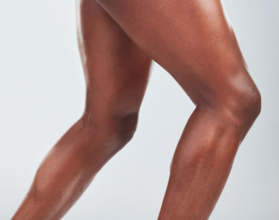 Close-up of a person's crossed legs, highlighting muscle tone