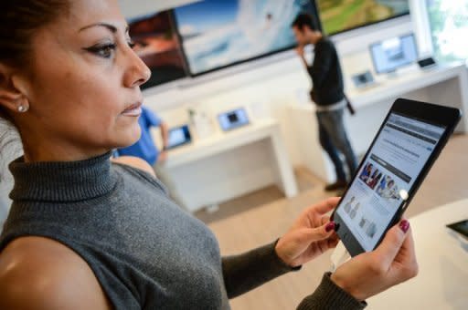 Customers look at the new iPad mini at an Apple store in Rome. Apple's new iPad mini debuted on Friday with less fanfare than previous incarnations amid talk it might have come too late to the 7-inch tablet computer market