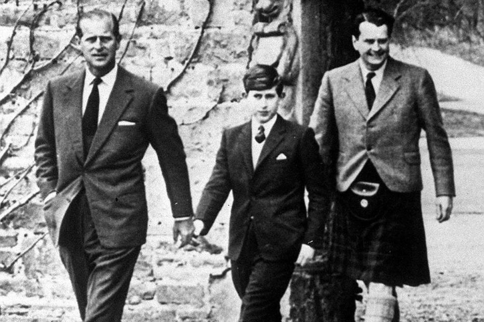 Prince Philip with Prince Charles arriving at Gordonstoun for the Prince's first day at Public School (PA)