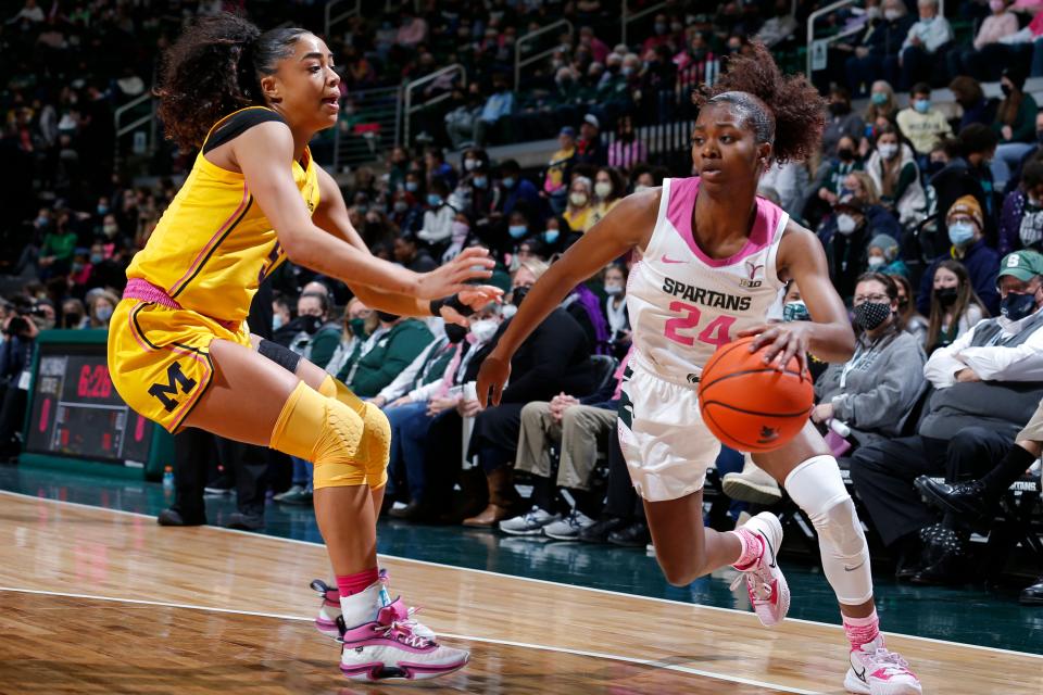 Michigan State's Nia Clouden, right, drives against Michigan's Laila Phelia during the first half Thursday, Feb. 10, 2022, at Breslin Center in East Lansing.