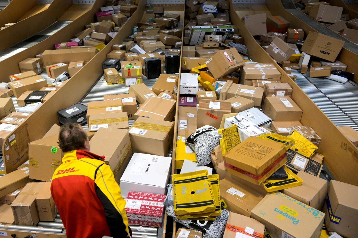 delivery An employee works at a distribution centre of German postal and logistics group Deutsche Post DHL in Hamburg, Germany, December 8, 2022. REUTERS/Fabian Bimmer