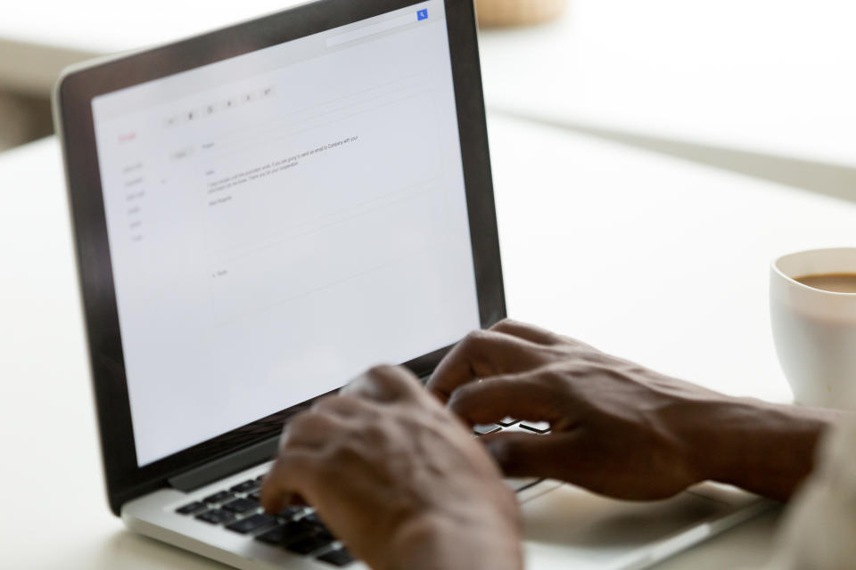 Man sending an email at work. (Getty Images)