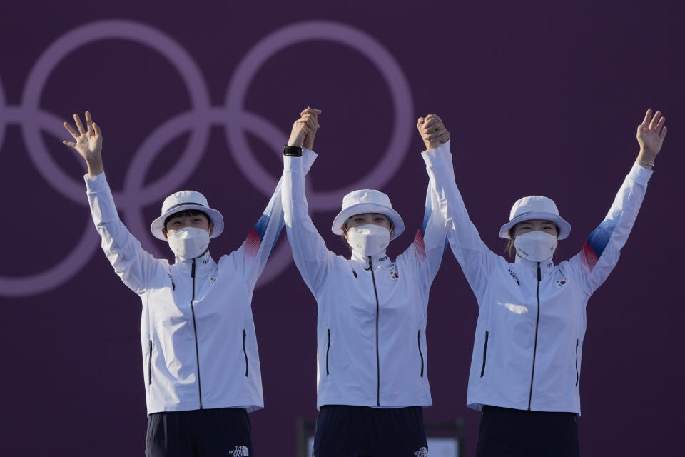 From left first placed South Korea's An San, Jang Minhee, and Kang Chaeyoung celebrate on the podium during the medal ceremony of the women's team competition at the 2020 Summer Olympics, Sunday, July 25, 2021, in Tokyo, Japan. (AP Photo/Alessandra Tarantino)